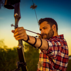 Young archer training with the bow at the 3D archery range at Royal Stag Preserve
