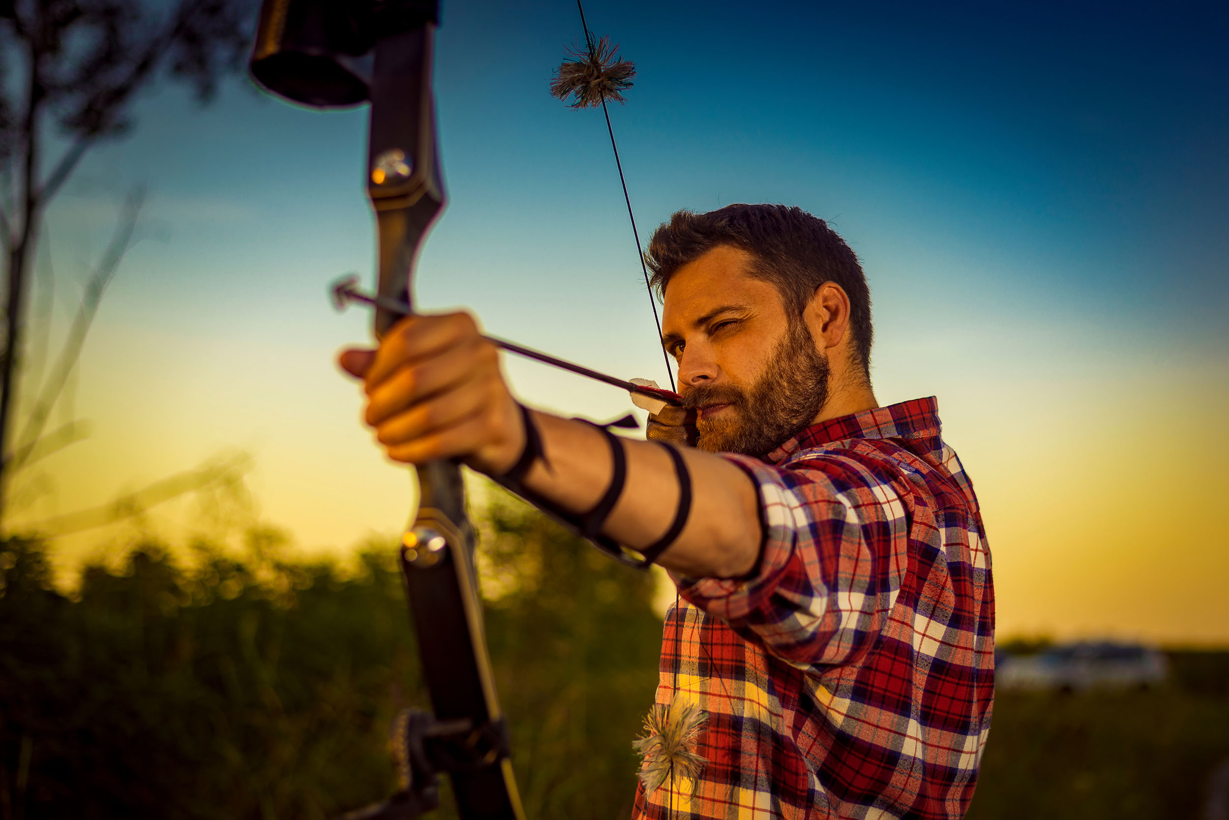 Young archer training with the bow at the 3D archery range at Royal Stag Preserve